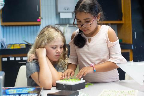 Two young girls work together on project at Girls Inc.