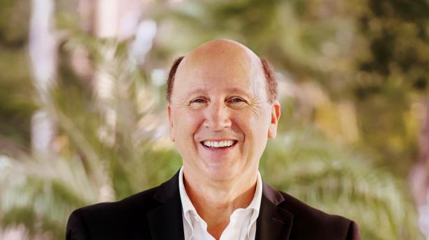 Mark Pritchett, President|CEO of Gulf Coast Community Foundation, smiling, standing.