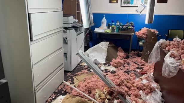 Damaged office with Pink insulation scattered