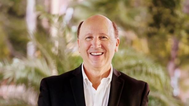 Dr. Mark S. Pritchett, President|CEO of Gulf Coast Community Foundation, standing and smiling.