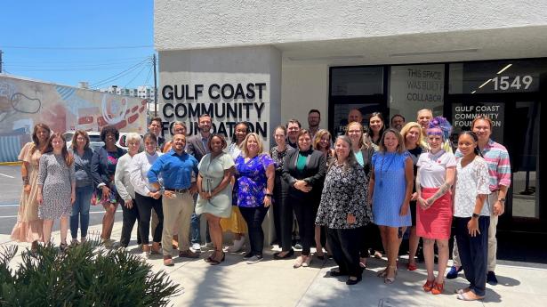 About 15 people stand outside of Gulf Coast Community Foundation's downtown Sarasota Philanthropy Center.