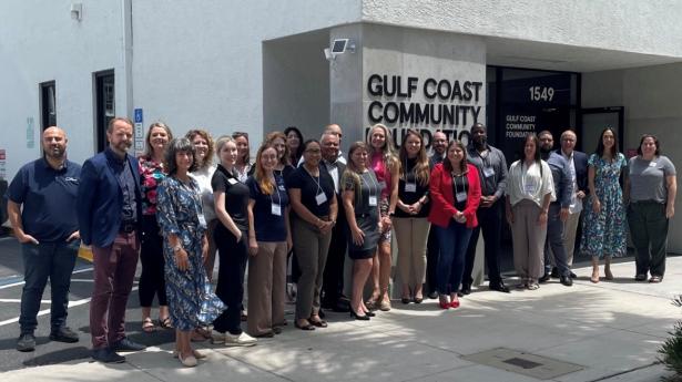 About 25 people gather outside of Gulf Coast Community Foundation's Sarasota Philanthropy Center.