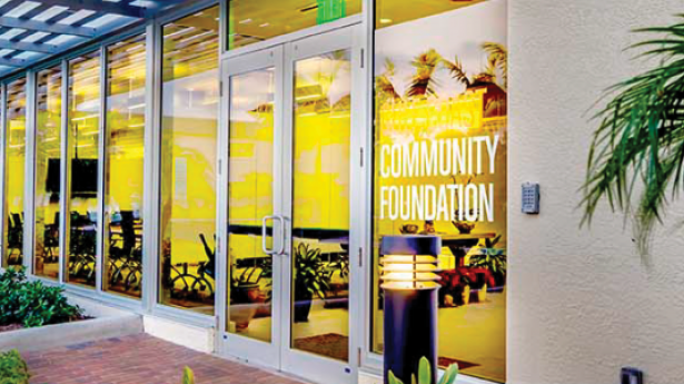 outside of an office with glass doors and trees around