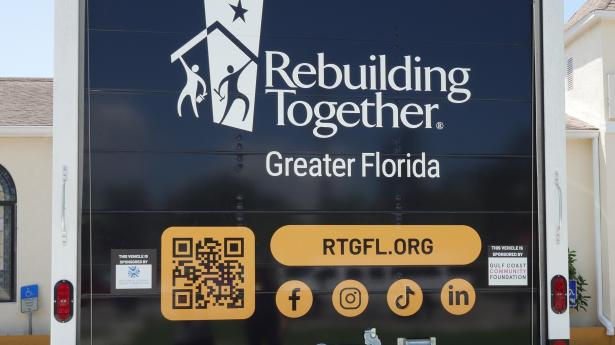 back of a large truck door that says "Rebuilding Together"