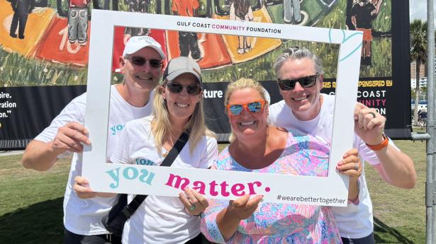 2 women and 2 men hold a selfie frame around themselves that says YOU MATTER and smiling at the camera