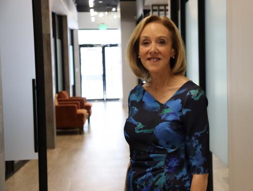 Deb Kabinoff, a philanthropic friend of Gulf Coast Community Foundation, stands and smiles at Gulf Coast Community Foundation's Sarasota Philanthropy Center.
