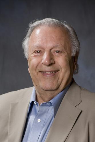 Man in suit smiling at camera.