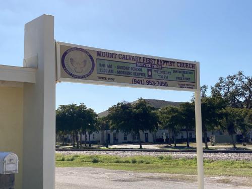 Sign for Mount Calvary First Baptist Church outside of church entrance.