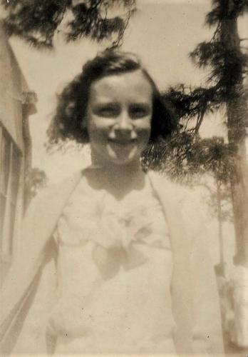 Julia Cousins Laning age fifteen in 1936 smiling at camera.