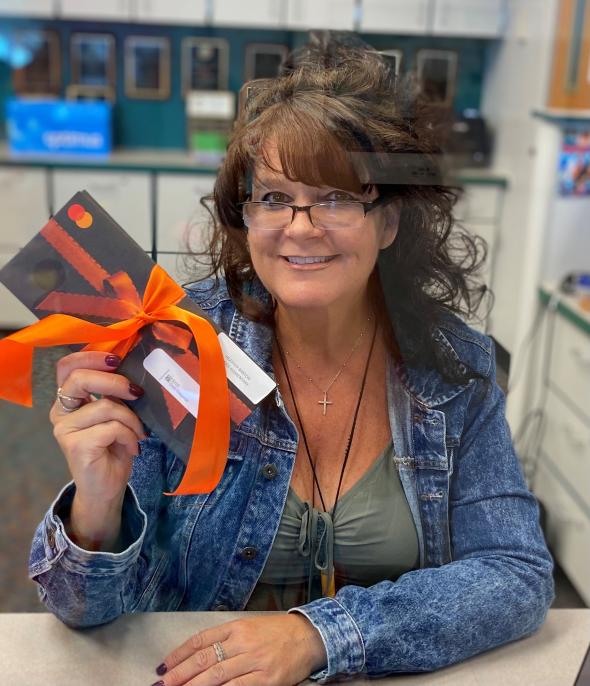 Teacher holding gift card